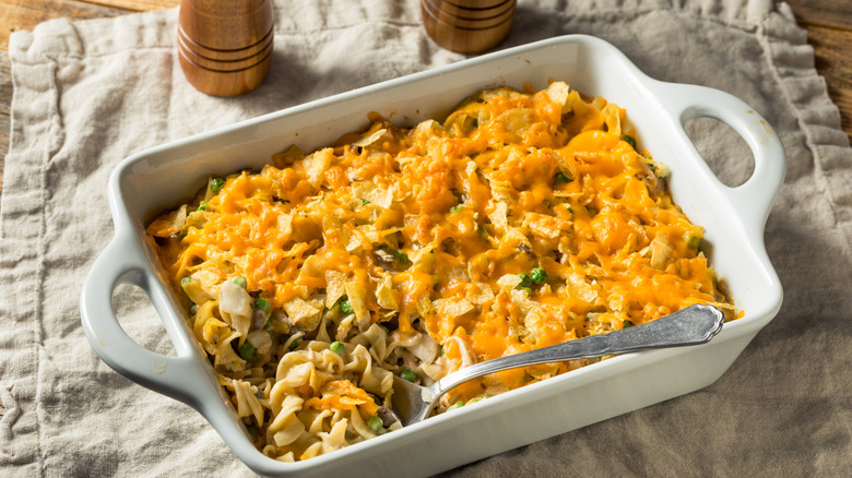A homemade tuna casserole in a white ceramic dish on a table
