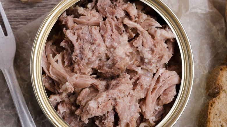 Top-down closeup view of canned chicken