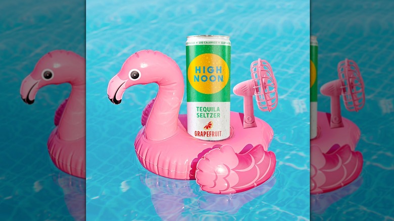 High Noon Grapefruit Tequila Seltzer in pink pool floatie