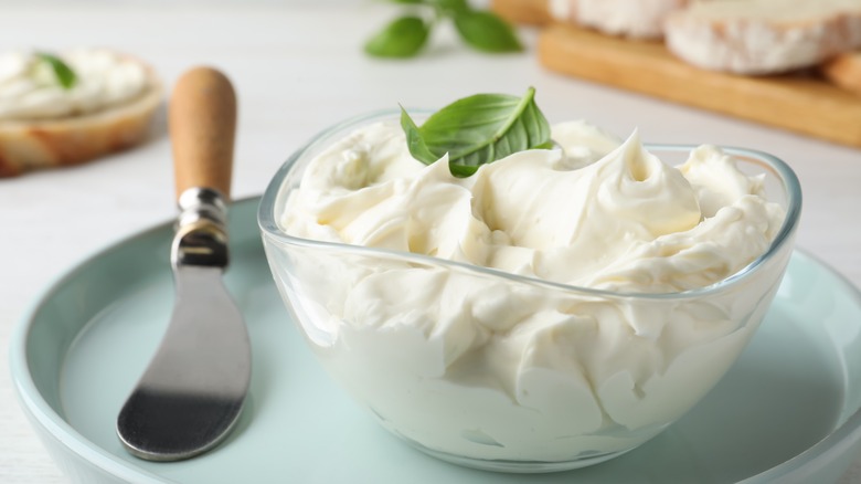 Bowl of cream cheese with a knife
