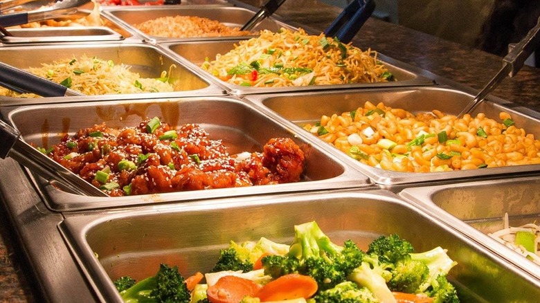 Tongues and trays full of Chinese dishes at Grand China Buffet Sushi and Grill