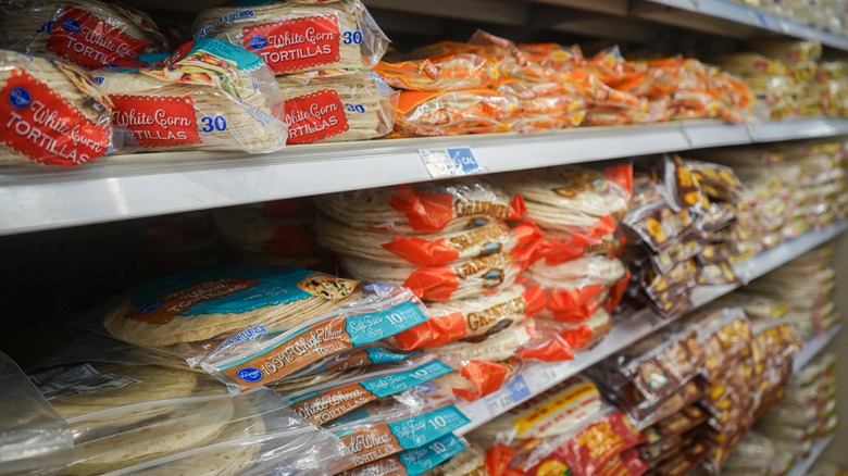 packages of toortillas on grocery shelves