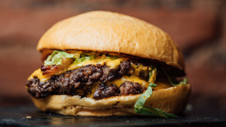 smash burger with cheese and lettuce