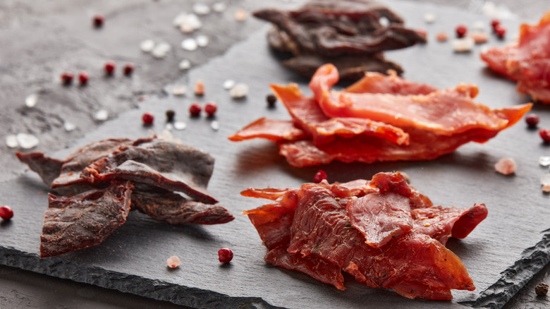 different kinds of jerky on a gray slate