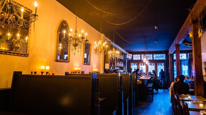 Booths and chandeliers inside a Seattle date night pizza spot