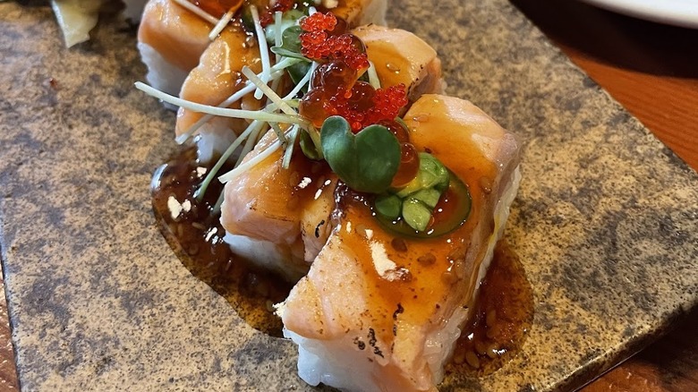 Salmon sushi with red caviar on a granite plate at a Seattle sushi restaurant for couples