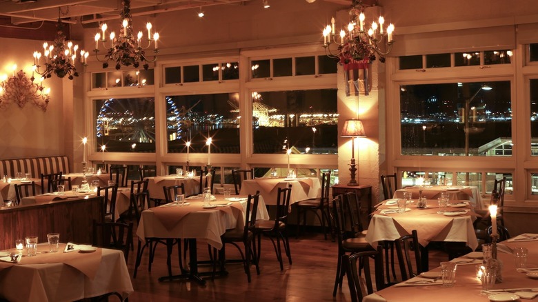 Seattle date night spot for couples with white tablecloths and chandeliers in dining room