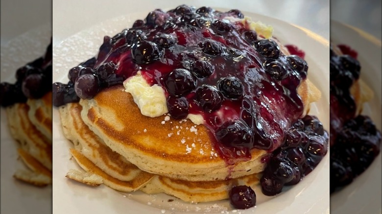 Pancakes topped with blueberries and whipped cream at Broad Street Diner