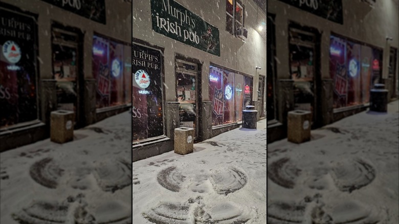 Murph's Irish Pub with a snow angel in the front lot