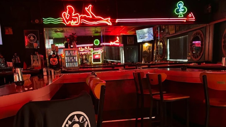 Inside of Mac's Club Deuce with neon signs above bar