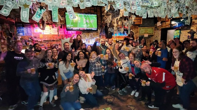 Interior of Edna's with patrons posing
