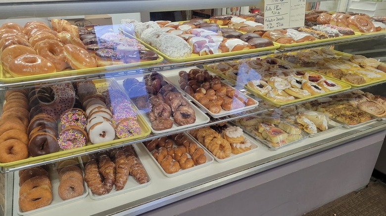 Donuts from the Olsen Bake Shop displayed behind glass