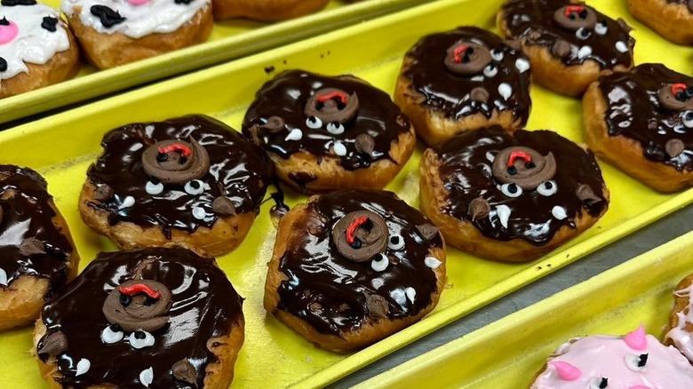 Decorated donuts on yellow tray