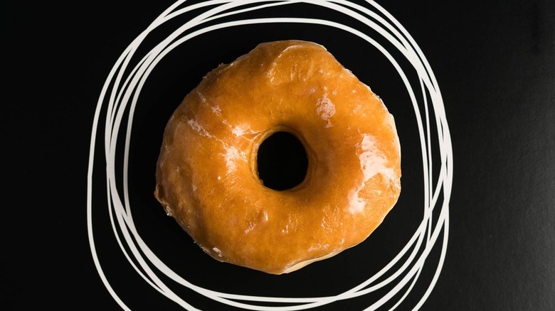 Glazed donut on black background