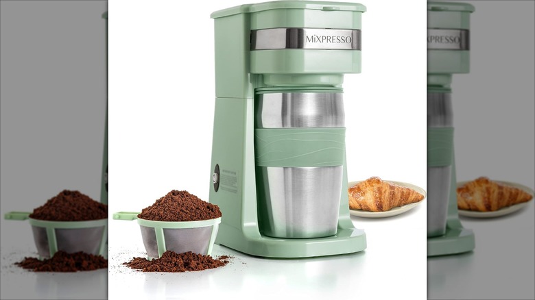 Green Mixpresso personal single serve coffee maker with coffee grounds in filter and croissant