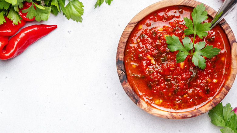 Spicy-looking red marinade in wooden bowl