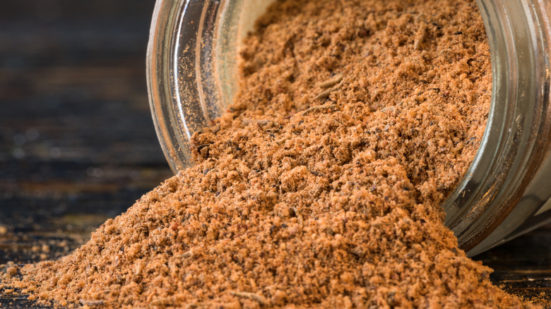 Jerk seasoning spilling out of a jar