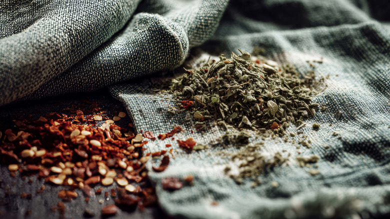Ground dired herbs and red chili flakes on cloth