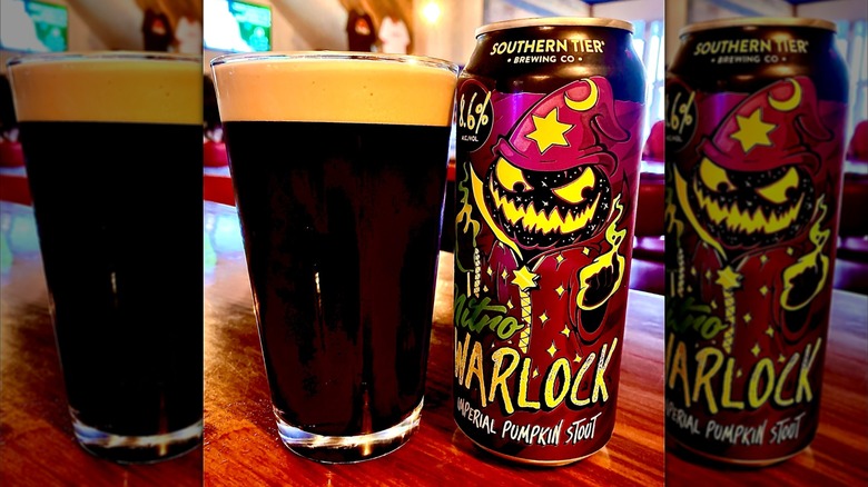 Can of Southern Tier Nitro Warlock Imperial Pumpkin Stout alongside glass full of beer on table