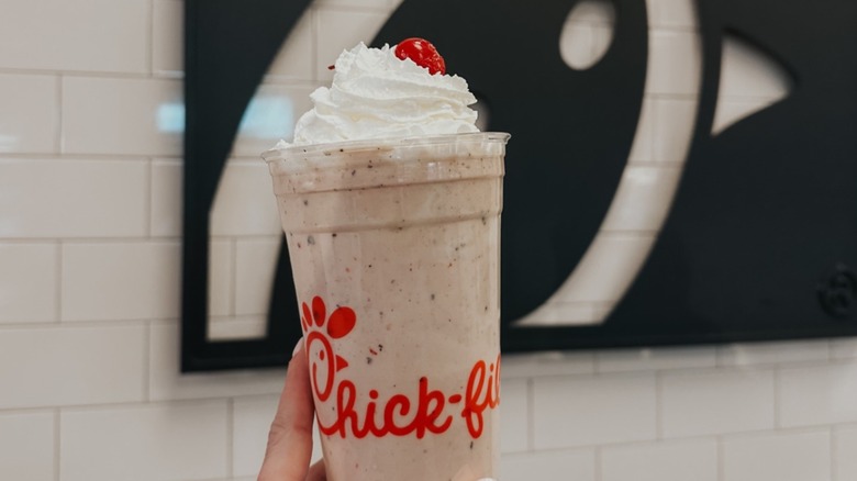 Hand holding Chick-fil-A Peppermint Chip Milkshake