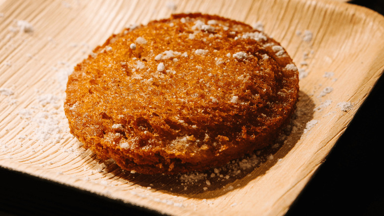 Crispy uncrustable sandwich on a wooden plate