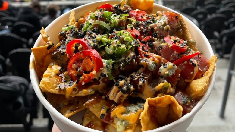 Wonton chips with nacho toppings in a cup