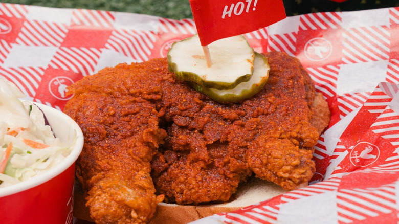 hattie b's hot chicken sandwich on outdoor platter