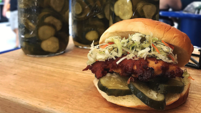 fat rooster chicken sandwich displayed on butcher block