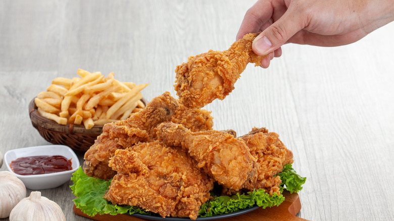 platter of fried chicken with hand