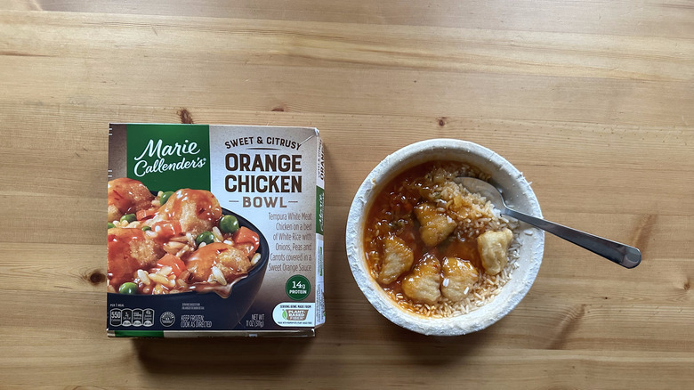 Marie Callender's orange chicken in its microwaveable plate with a spoon