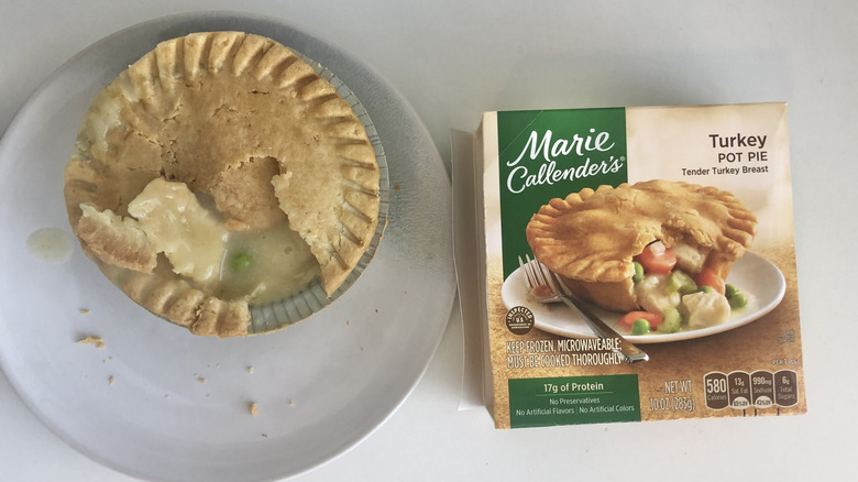 Marie Callender's turkey pot pie on a white plate with the package nearby.