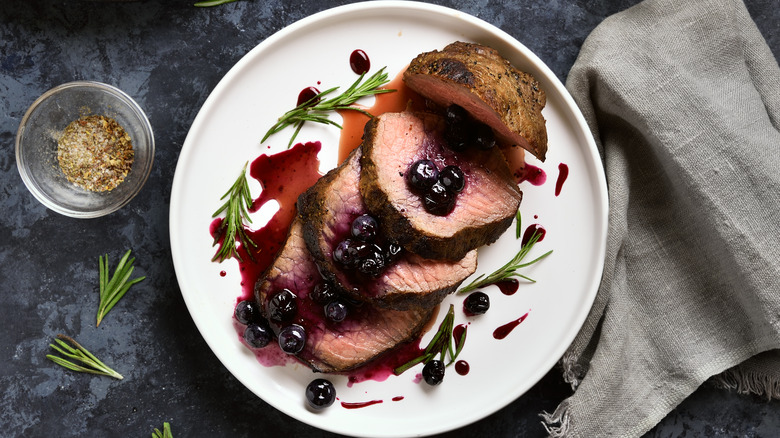 steak topped with blueberry sauce