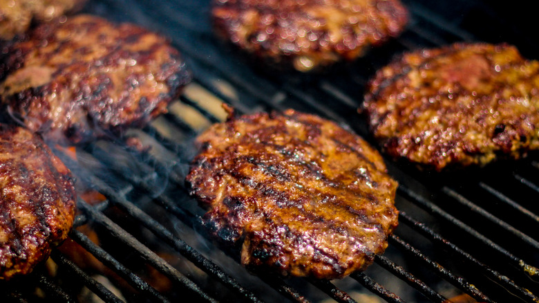 Juicy burger patties on a grill