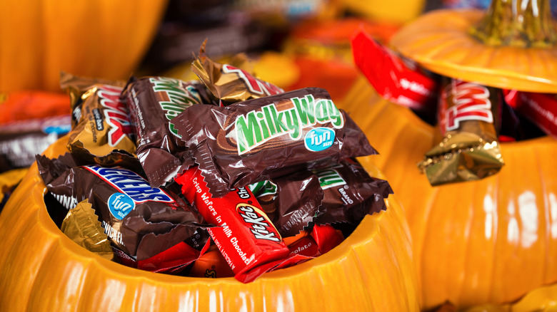 Two plastic pumpkins filled with Hershey's candy