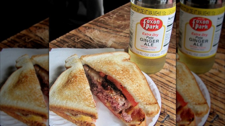 Hamburger on white toast with a bottle of ginger ale