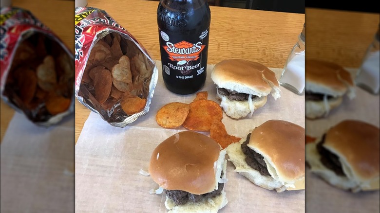 Three double sliders with bottle of root beer and bag of chips