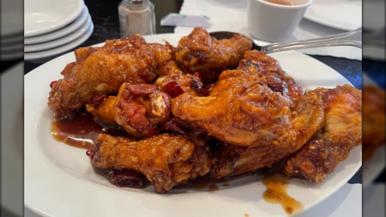 Plate of dry-fried wings covered with sauce