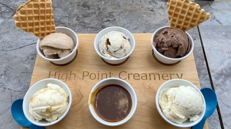 Flight with five flavors of ice cream, served alongside hot fudge and waffle cone triangles