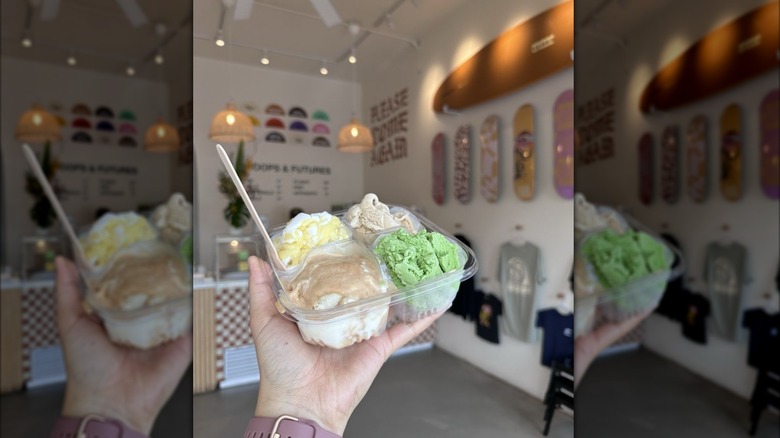 Hand holding flight of ice cream in surf and skate themed shop