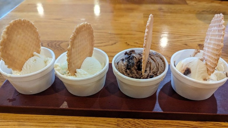 Flight of four ice creams, each topped with waffle cone round