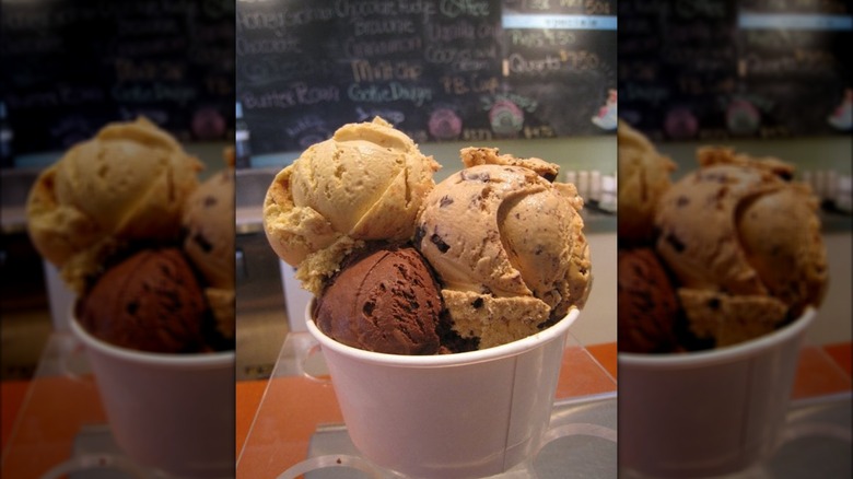Three scoops of variously flavored ice cream stuffed into bowl