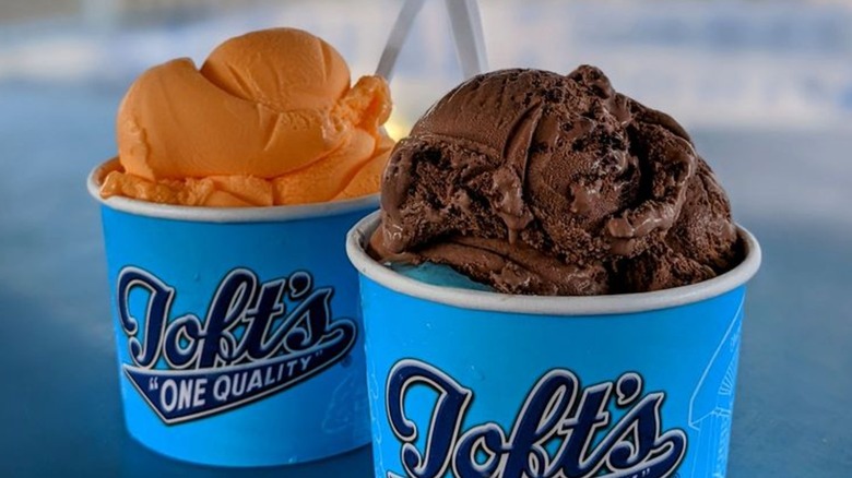 Two cups of ice cream, one Orange Sherbet and one Brownie Bandit