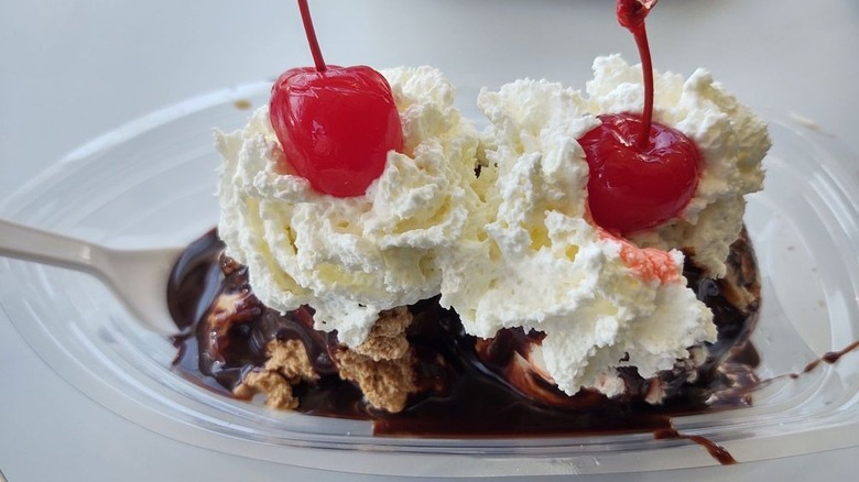 Ice cream sundae with chocolate sauce, whipped cream, and two cherries