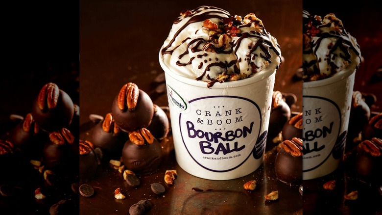 A pint of Bourbon Ball ice cream topped with chocolate drizzle and pecans