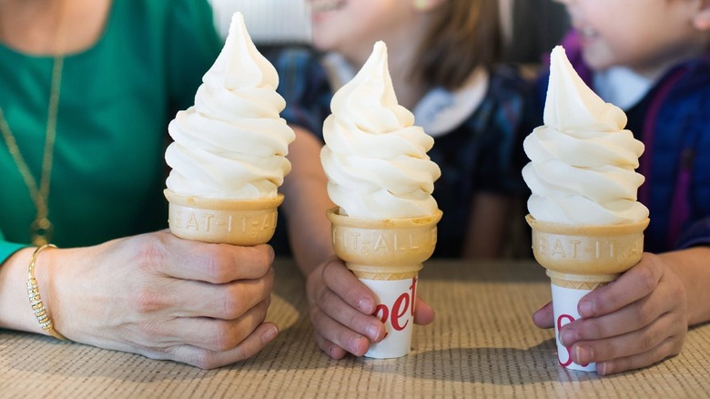 Three people holding Icedream Cones