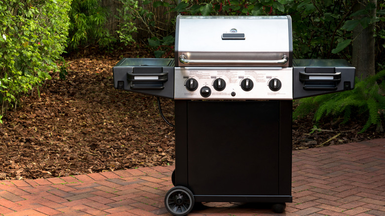 A gas grill on a patio