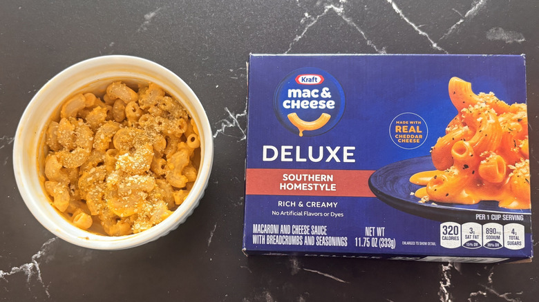 Box of Kraft Southern Homestyle mac and cheese next to bowl of it prepared
