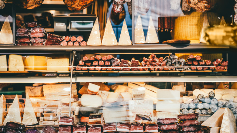 Retail counter with cheeses and cured meats