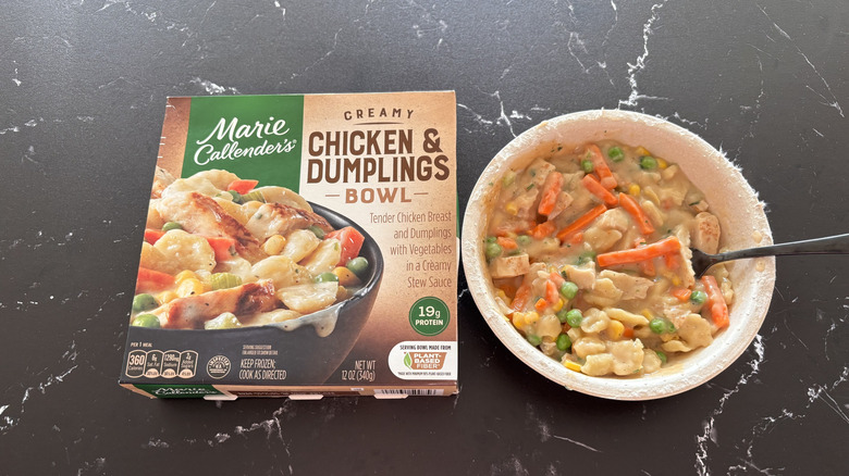 The Marie Callender's Chicken and Dumplings bowl sits on a marble countertop next to its box.