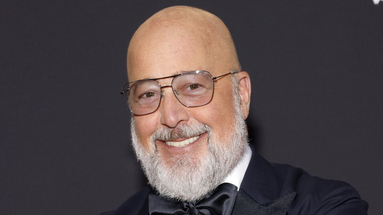 Andrew Zimmern smiling with glasses